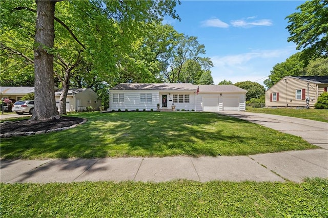 6526 Marty St, Overland Park, KS 66202 - view of front facade featuring driveway and a front lawn
