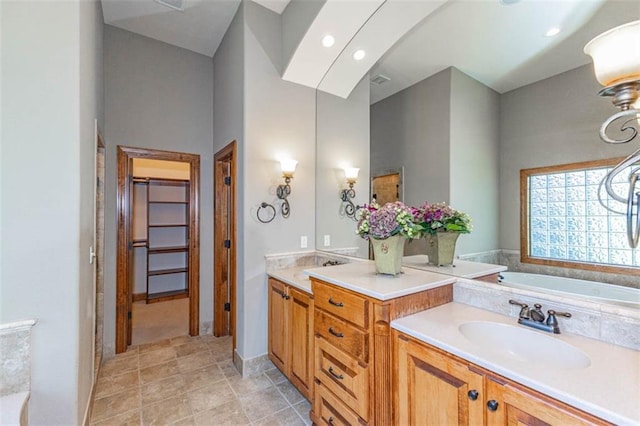 26650 W 100th Pl, Olathe, KS 66061 - bathroom featuring double vanity, a bath, recessed lighting, and tile patterned flooring