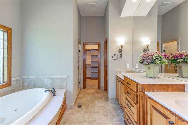 26650 W 100th Pl, Olathe, KS 66061 - bathroom featuring healthy amount of natural light, a jetted tub, vanity, and baseboards