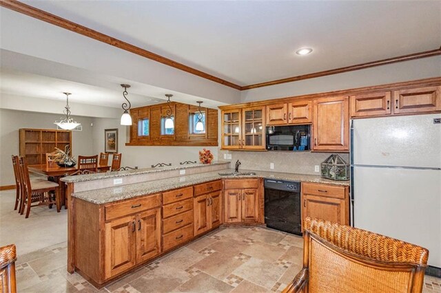 26650 W 100th Pl, Olathe, KS 66061 - kitchen featuring black appliances, a sink, a peninsula, brown cabinetry, and light stone countertops