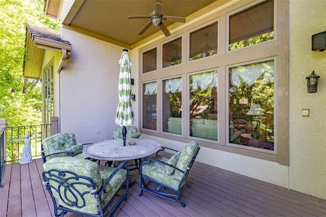 26650 W 100th Pl, Olathe, KS 66061 - wooden terrace featuring ceiling fan and outdoor dining area