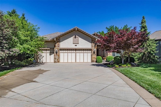 26650 W 100th Pl, Olathe, KS 66061 - view of front of property featuring stucco siding, a garage, concrete driveway, stone siding, and a front lawn