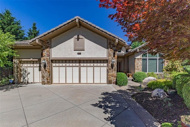 26650 W 100th Pl, Olathe, KS 66061 - view of front of house with stone siding, stucco siding, and an attached garage