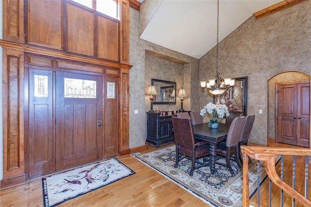 26650 W 100th Pl, Olathe, KS 66061 - dining area with high vaulted ceiling, a chandelier, light wood-style floors, and healthy amount of natural light