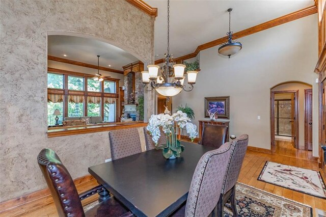 26650 W 100th Pl, Olathe, KS 66061 - dining area featuring arched walkways, ceiling fan, ornamental molding, hardwood / wood-style flooring, and a chandelier