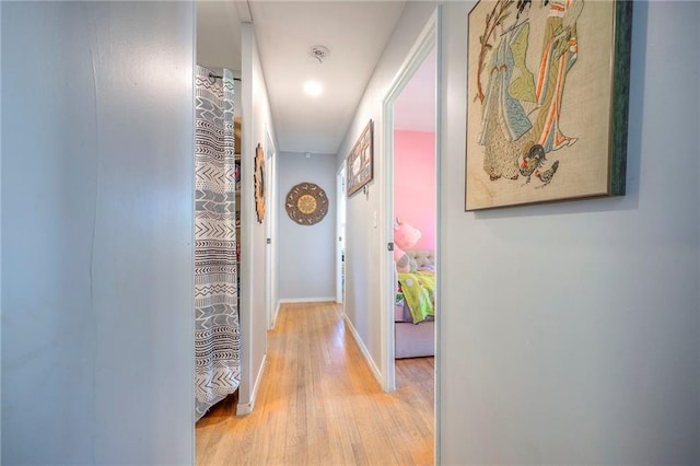 205 N 82nd Ter, Kansas City, KS 66112 - corridor featuring attic access, light wood-style flooring, and baseboards