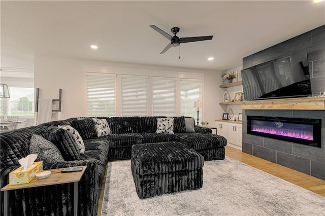 2241 Foxtail Dr, Kearney, MO 64060 - living area with ceiling fan, light wood-style flooring, recessed lighting, and a glass covered fireplace