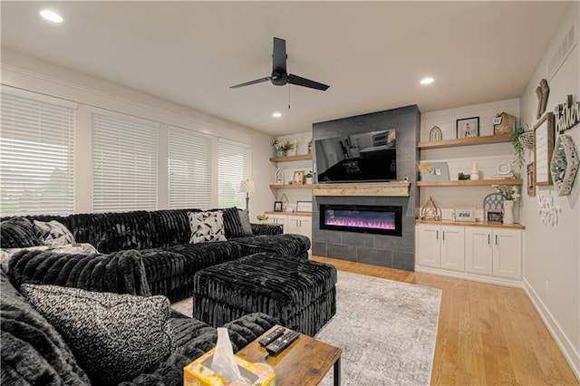 2241 Foxtail Dr, Kearney, MO 64060 - living room with a ceiling fan, light wood-style floors, a glass covered fireplace, recessed lighting, and baseboards