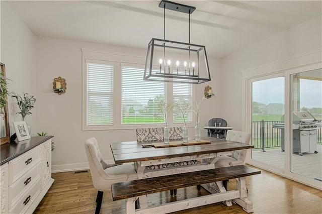 2241 Foxtail Dr, Kearney, MO 64060 - dining space featuring a chandelier, light wood-style flooring, and baseboards