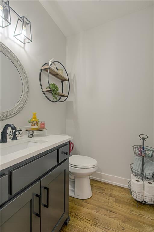 2241 Foxtail Dr, Kearney, MO 64060 - half bath with wood finished floors, vanity, toilet, and baseboards