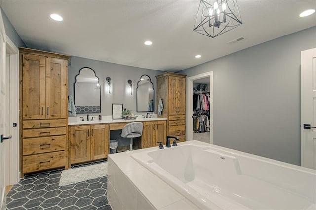 2241 Foxtail Dr, Kearney, MO 64060 - bathroom with recessed lighting, a garden tub, double vanity, and a spacious closet