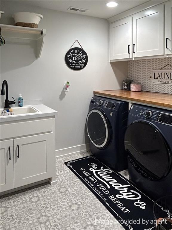 2241 Foxtail Dr, Kearney, MO 64060 - washroom with washing machine and clothes dryer, cabinet space, baseboards, and recessed lighting