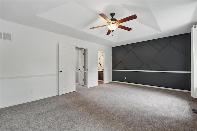 15642 W 146th Ter, Olathe, KS 66062 - carpeted empty room with a ceiling fan, baseboards, and a raised ceiling