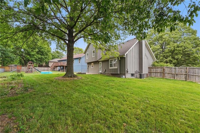 15642 W 146th Ter, Olathe, KS 66062 - rear view of house with board and batten siding and a playground