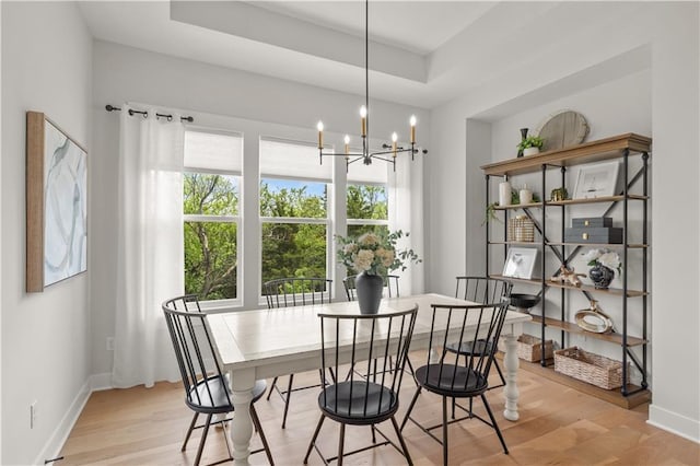 11573 S Mize Rd, Olathe, KS 66061 - dining space featuring light wood-style floors, a chandelier, and baseboards