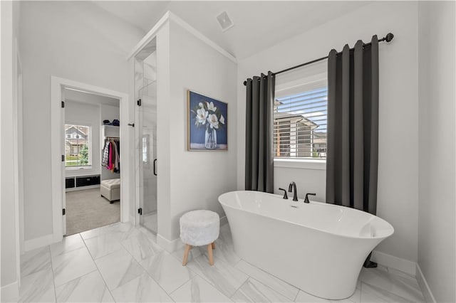 11573 S Mize Rd, Olathe, KS 66061 - bathroom with marble finish floors, a freestanding bath, and baseboards