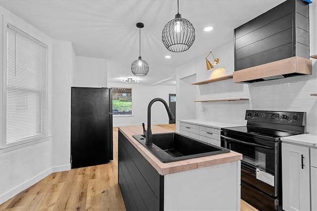 527 Cypress Ave, Kansas City, MO 64124 - kitchen featuring black appliances, a sink, an island with sink, white cabinets, and recessed lighting