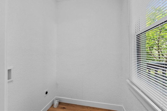 527 Cypress Ave, Kansas City, MO 64124 - laundry room featuring baseboards, electric dryer hookup, and wood finished floors