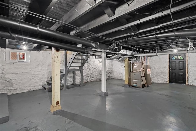 527 Cypress Ave, Kansas City, MO 64124 - unfinished below grade area featuring stairs, heating unit, and water heater
