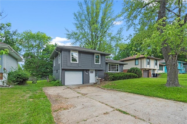 8003 E 118th Ter, Kansas City, MO 64134 - tri-level home with driveway, a front yard, an attached garage, and brick siding