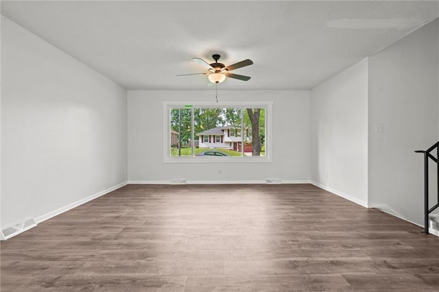8003 E 118th Ter, Kansas City, MO 64134 - empty room with a ceiling fan, dark wood-style floors, and baseboards