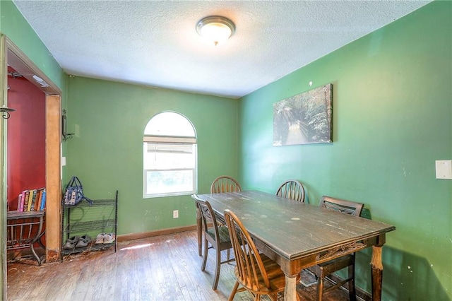 5316 NE 49th St, Kansas City, MO 64119 - dining space with a textured ceiling and wood-type flooring