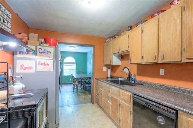 5316 NE 49th St, Kansas City, MO 64119 - kitchen with black dishwasher, dark countertops, a textured ceiling, freestanding refrigerator, and light floors
