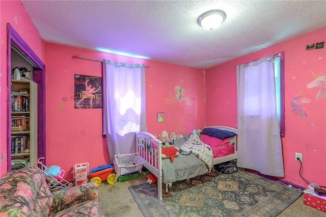 5316 NE 49th St, Kansas City, MO 64119 - bedroom featuring a textured ceiling and carpet flooring