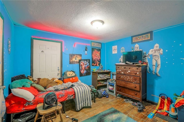 5316 NE 49th St, Kansas City, MO 64119 - bedroom with a textured ceiling and wood finished floors
