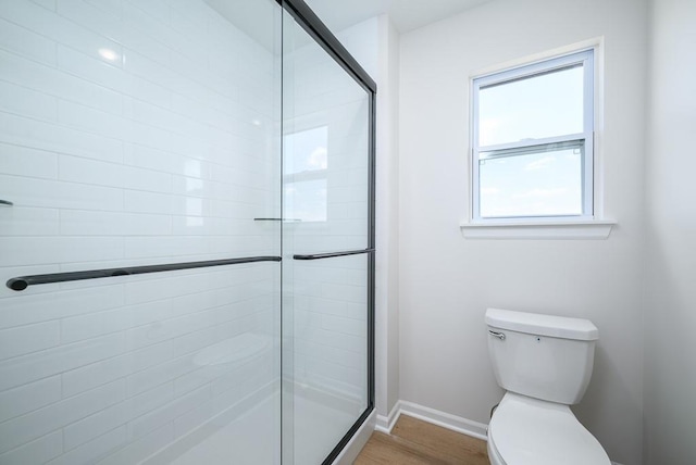 1012 2nd St, Perry, KS 66073 - full bath featuring a shower stall, wood finished floors, baseboards, and toilet