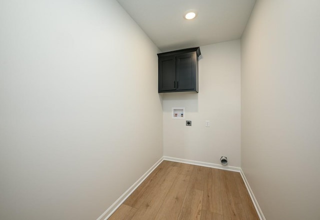 1012 2nd St, Perry, KS 66073 - clothes washing area with hookup for an electric dryer, cabinet space, washer hookup, light wood-style flooring, and baseboards