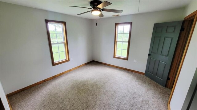 13106 Quinn Rd, Pleasanton, KS 66075 - carpeted empty room with healthy amount of natural light, a ceiling fan, and baseboards