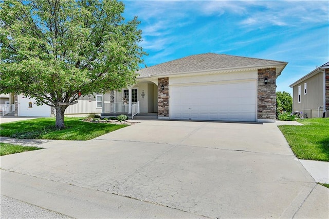 4641 SW Soldier Dr, Lees Summit, MO 64082 - ranch-style home with concrete driveway, stone siding, an attached garage, covered porch, and a front lawn