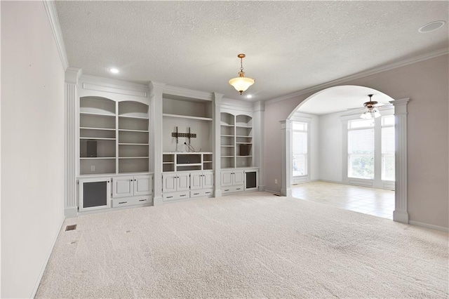 4641 SW Soldier Dr, Lees Summit, MO 64082 - carpeted empty room featuring arched walkways, a textured ceiling, ornamental molding, ceiling fan, and baseboards