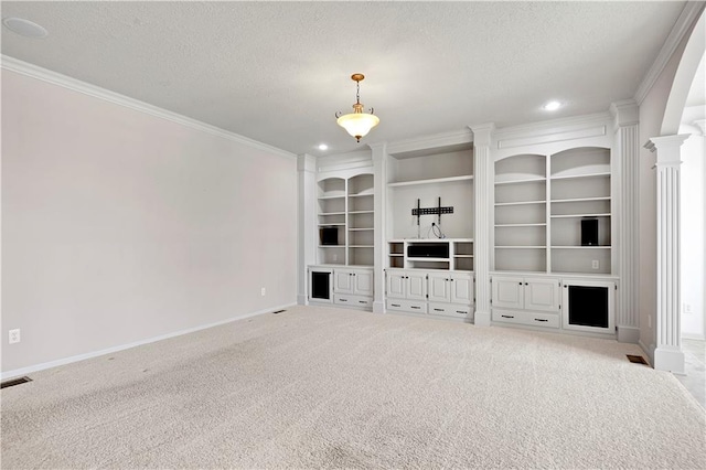 4641 SW Soldier Dr, Lees Summit, MO 64082 - unfurnished living room with baseboards, a textured ceiling, ornamental molding, carpet flooring, and decorative columns