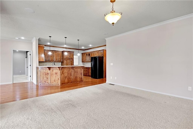 4641 SW Soldier Dr, Lees Summit, MO 64082 - kitchen with black fridge, open floor plan, light carpet, baseboards, and ornamental molding
