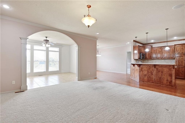 4641 SW Soldier Dr, Lees Summit, MO 64082 - unfurnished living room with light carpet, arched walkways, ornamental molding, recessed lighting, and baseboards