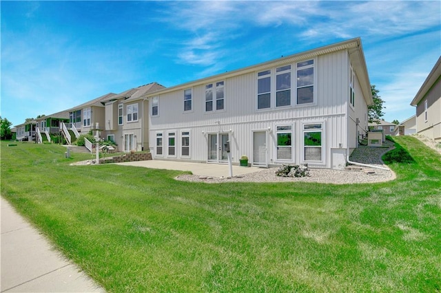 4641 SW Soldier Dr, Lees Summit, MO 64082 - rear view of property featuring a patio area, a lawn, and a residential view