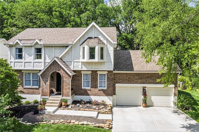 5208 NW 58th Ter, Kansas City, MO 64151 - tudor-style house featuring concrete driveway, stucco siding, brick siding, and roof with shingles