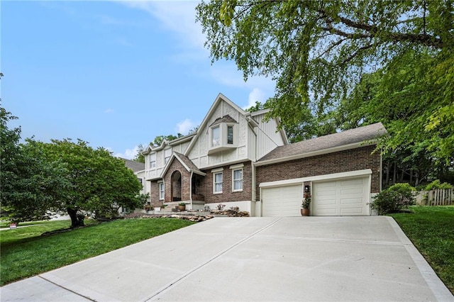 5208 NW 58th Ter, Kansas City, MO 64151 - tudor-style house with brick siding, a front lawn, an attached garage, and driveway