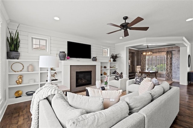 24957 W 98th St, Lenexa, KS 66227 - living area with crown molding, a tile fireplace, ceiling fan, dark wood finished floors, and a chandelier