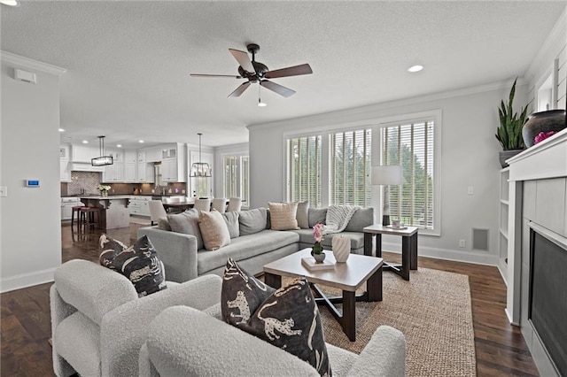 24957 W 98th St, Lenexa, KS 66227 - living area featuring recessed lighting, crown molding, a ceiling fan, baseboards, and dark wood-style flooring
