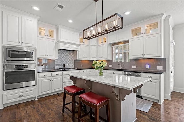 24957 W 98th St, Lenexa, KS 66227 - kitchen with stainless steel appliances, a sink, dark wood-type flooring, white cabinetry, and recessed lighting
