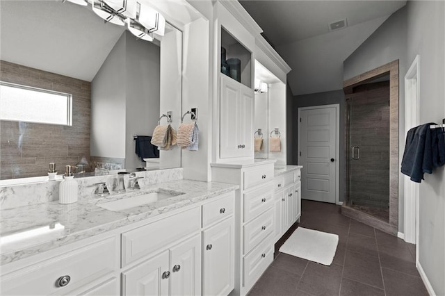 24957 W 98th St, Lenexa, KS 66227 - bathroom with lofted ceiling, vanity, a shower stall, tile patterned flooring, and baseboards