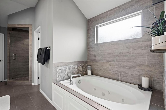 24957 W 98th St, Lenexa, KS 66227 - full bathroom featuring a jetted tub, a stall shower, tile patterned flooring, lofted ceiling, and baseboards