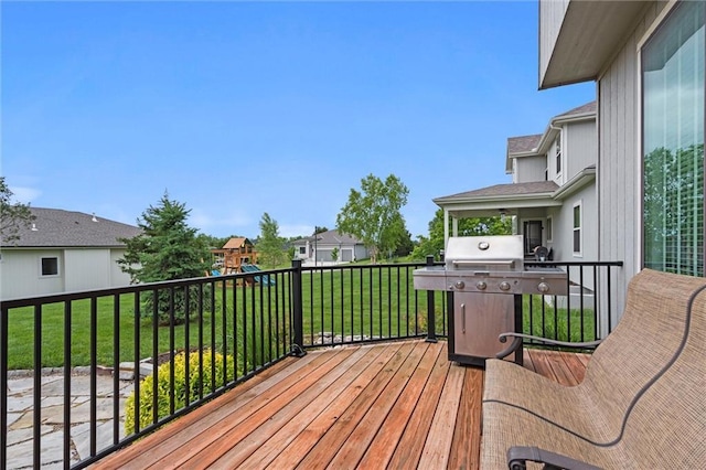 24957 W 98th St, Lenexa, KS 66227 - wooden terrace featuring a playground, a lawn, grilling area, and a residential view
