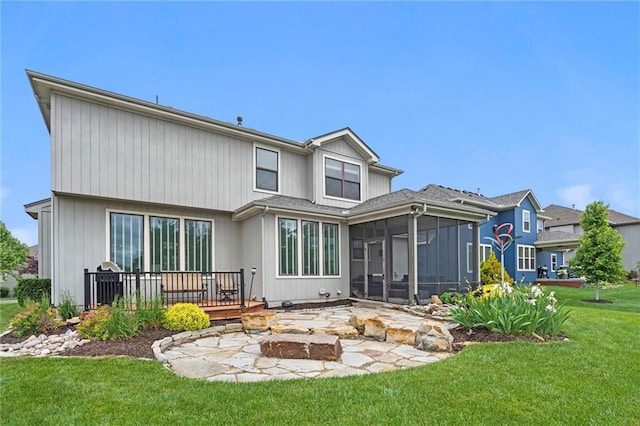 24957 W 98th St, Lenexa, KS 66227 - rear view of property with a sunroom, a fire pit, a wooden deck, and a yard