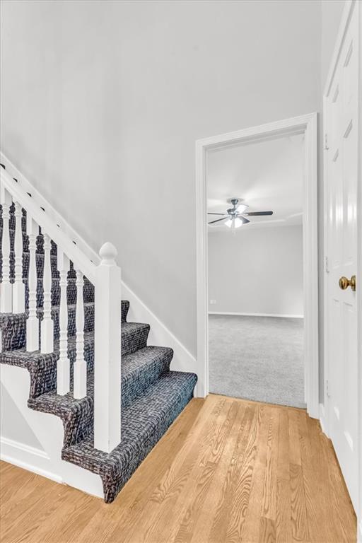 1600 NE 97th St, Kansas City, MO 64155 - stairway with ceiling fan and wood finished floors