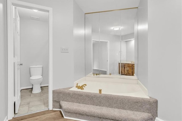 1600 NE 97th St, Kansas City, MO 64155 - full bathroom featuring a bath, toilet, and baseboards