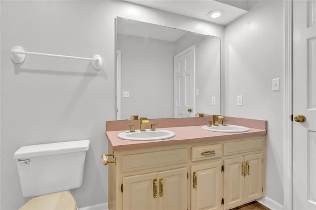1600 NE 97th St, Kansas City, MO 64155 - bathroom featuring double vanity, toilet, and baseboards